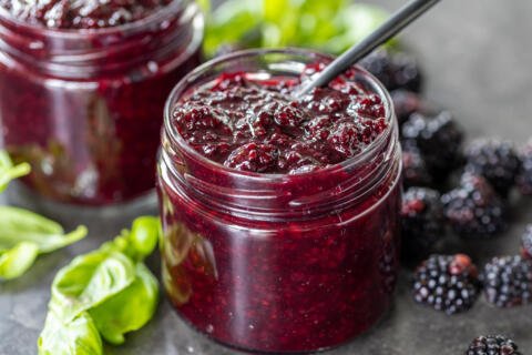 Blackberry Jam in a jar with another jam on the back.