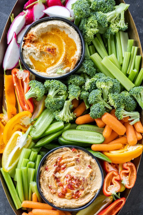 Veggies with hummus on a serving tray.