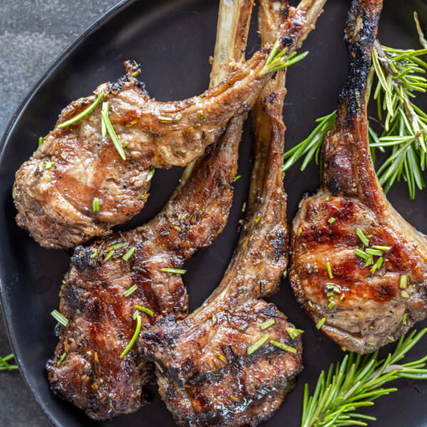 Grilled Lamb Chops on a plate with herbs.