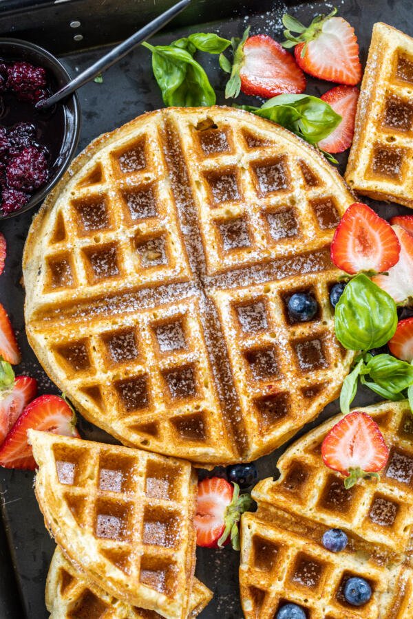 Oatmeal Cottage Cheese Waffles on a tray with berries. 