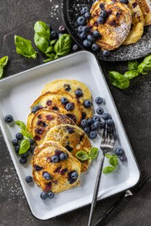Pancakes on a plate with blueberries.