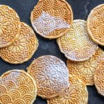 Pizzelle with powdered sugar.