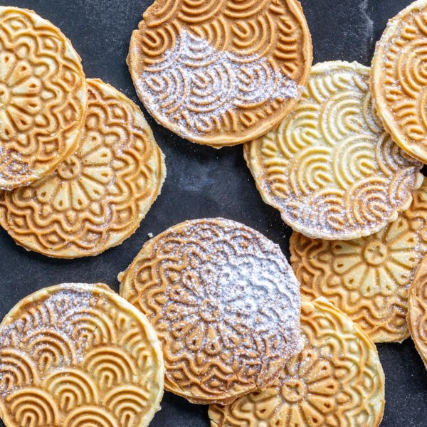Pizzelle on a tray next to each other.