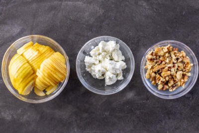 Pears, goat cheese and walnuts in bowls.