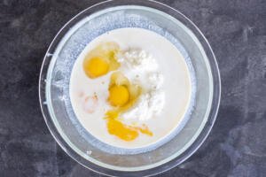 Ricotta and other liquid ingredients in a bowl.