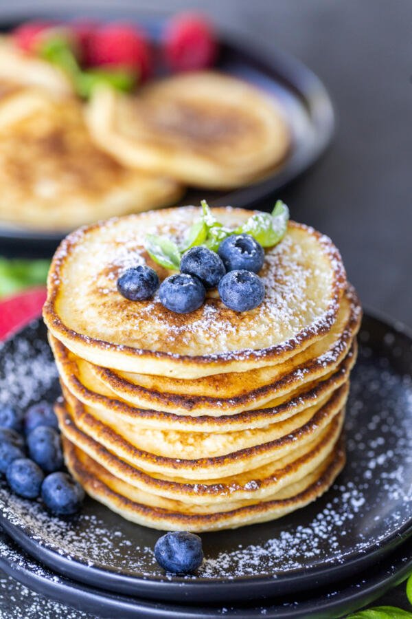 Ricotta Pancakes on a plate with berries. 