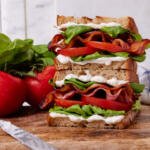 BLT sandwich on a serving board.