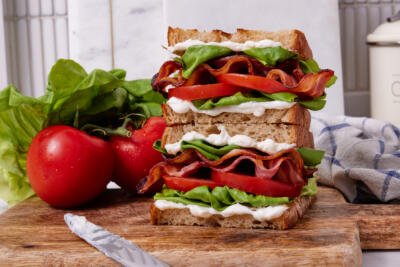 BLT sandwich on a serving board.