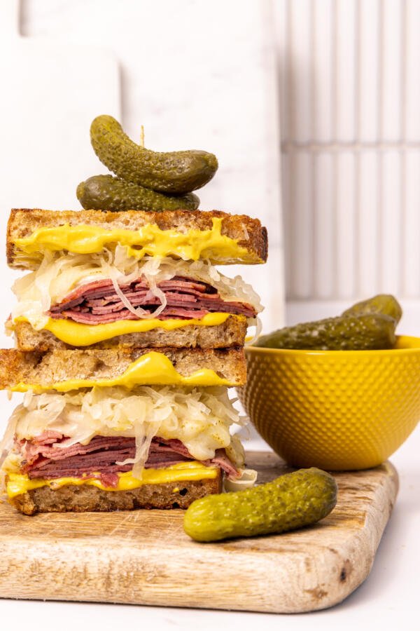 Pastrami Sandwich with pickles on the side.