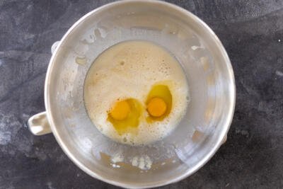 Eggs added to liquids in a bowl