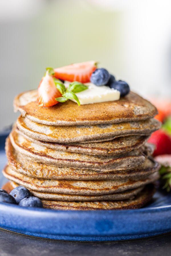 A plate with Buckwheat Pancakes and berries. 