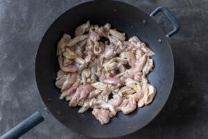 Chicken cooking in a wok.