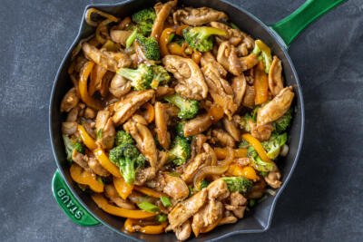 Chicken Stir Fry in a pan with sesame on top.