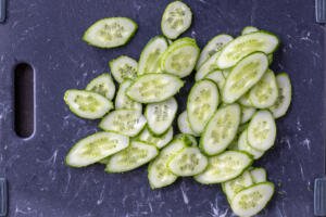 Sliced cucumbers on a cutting board.