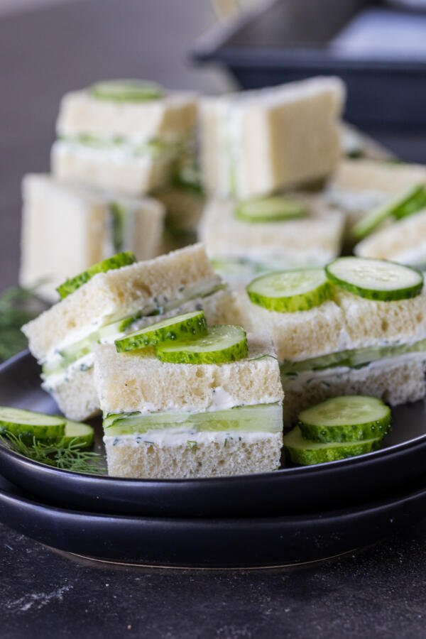 Sliced up Cucumber Sandwiches on a plate. 