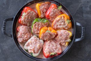 Unbaked Ground Beef Stuffed Peppers in a baking pan.