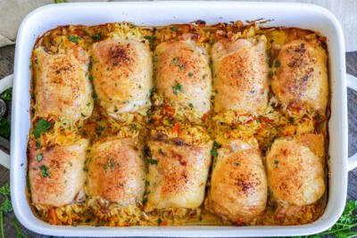 Baking pan with chicken stuffed with rice.