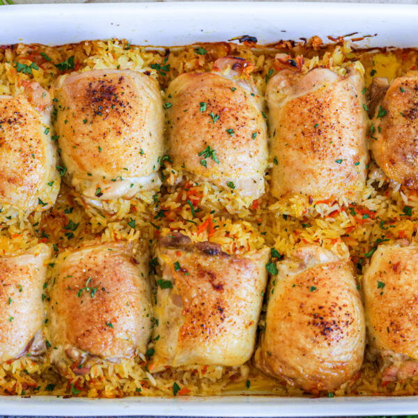 Baking pan with chicken stuffed with rice.