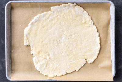 Galette crust dough on a baking sheet.