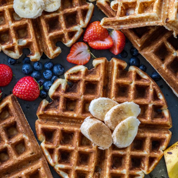 Banana Waffles with fruit next to it.