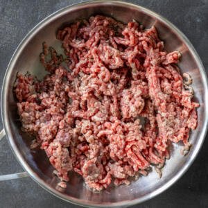 Ground beef cooking in a pan.