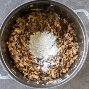 Mushrooms and flour in a bowl.