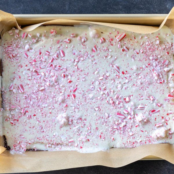 Peppermint Bark in a baking sheet lined with parchment.