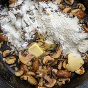 Ground, butter and mushrooms in a pan.