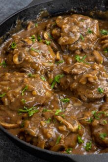 Salisbury Steak with herbs in a serving dish.