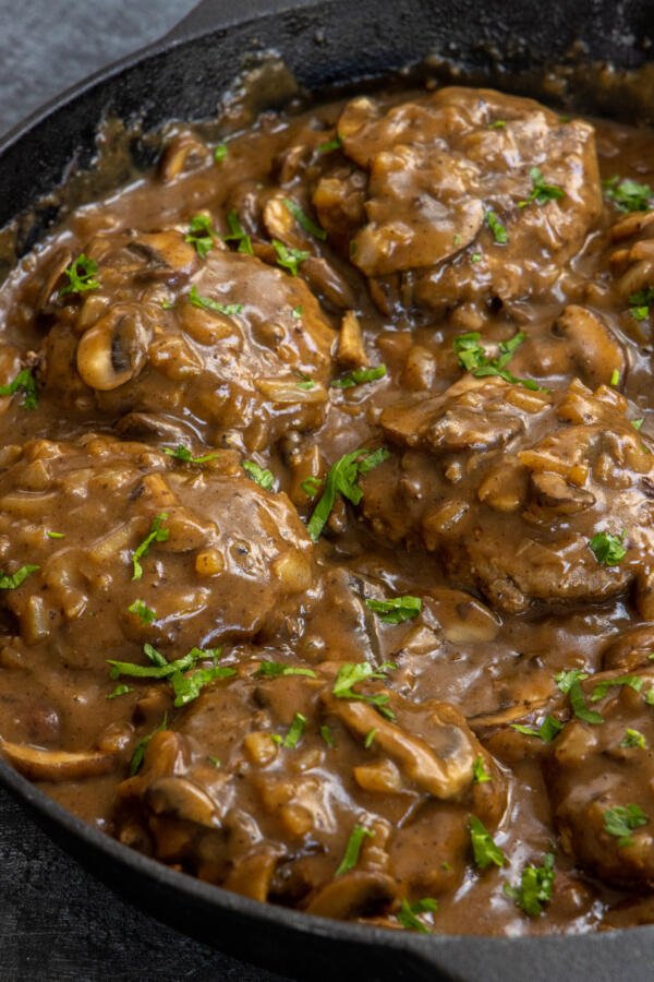 Salisbury Steak with herbs in a serving dish. 