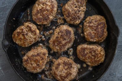 Meat patties in a pan.