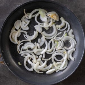 Sliced onions on a pan.