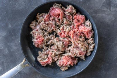 Shaved steak on a pan.