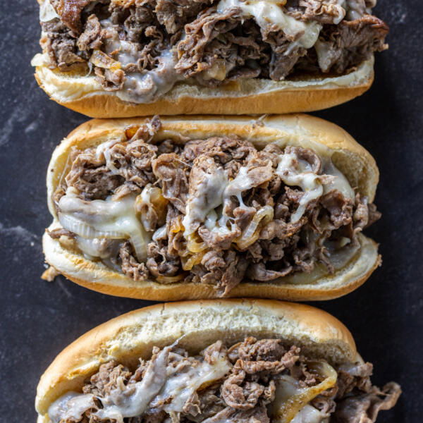 Baking sheet with Shaved Steak Sandwiches.
