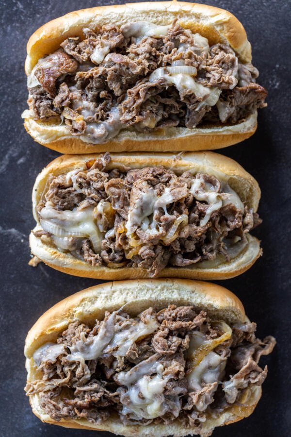 Baking sheet with Shaved Steak Sandwiches.