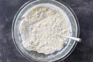 Wet ingredients combined in a bowl with dry ingredients.