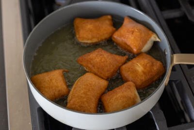 Frying Beignets in a pan.