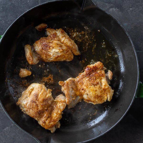 Chicken on a frying pan.