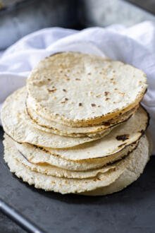 Cooked corn tortillas on top of each other.