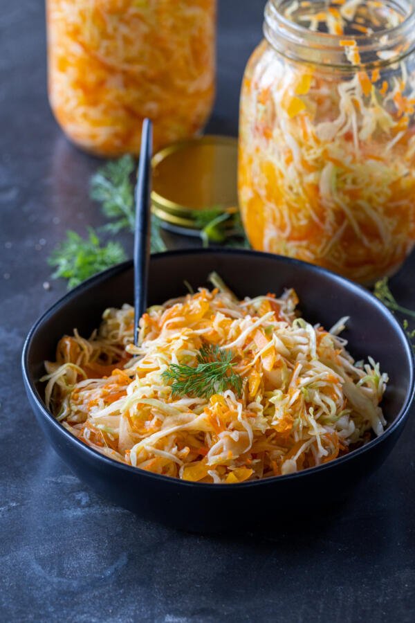 Pickled Cabbage in a bowl with herbs.