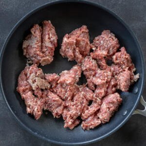 Meat browning in a pan.