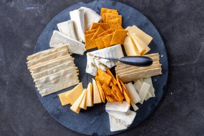 Cheese with crackers on a board.