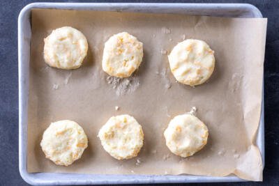 Potato pancakes shaped on a baking sheet.
