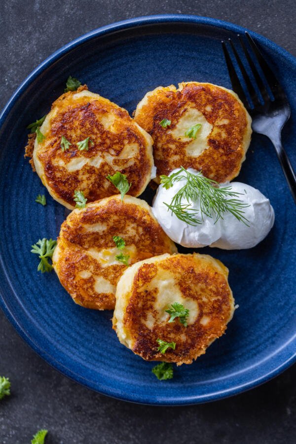 Mashed Potato Pancakes with herbs and sauce.