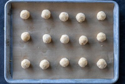 Peanut Butter Blossoms Bookie balls on a baking sheet.