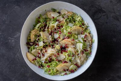 Shaved Brussels Sprout Salad in a bowl before dressing.
