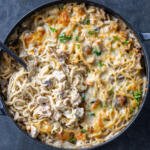 Turkey Tetrazzini in a pan with a spoon.