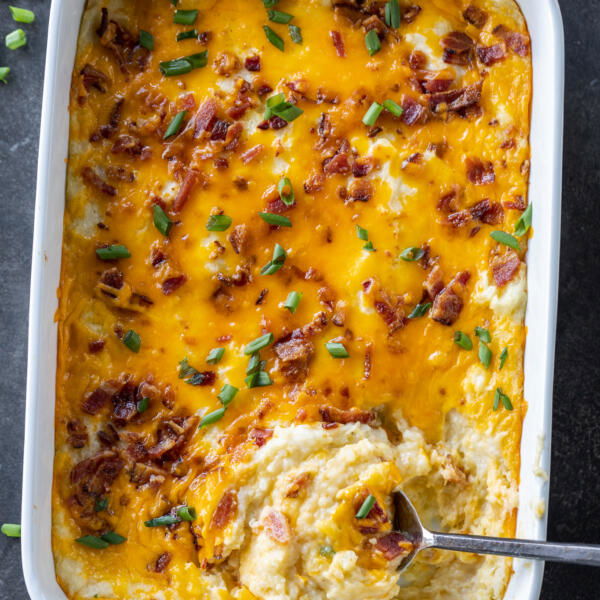 Twice Baked Potato Casserole in a pan with a spoon.