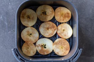 Sliced apples in an air fryer.