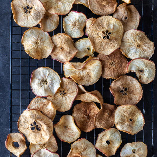 Crispy apple chips on a cooling rack.